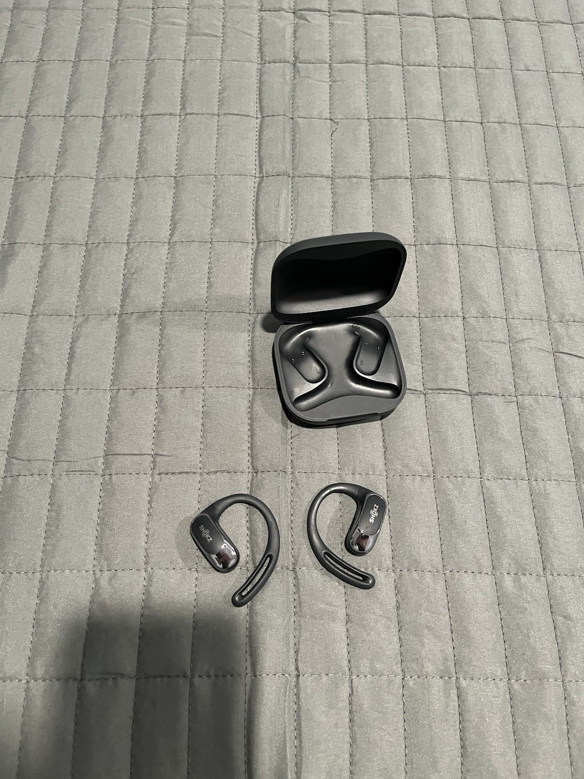 Shokz OpenFit True Wireless Open-Ear Bluetooth Earbuds with charging case black.