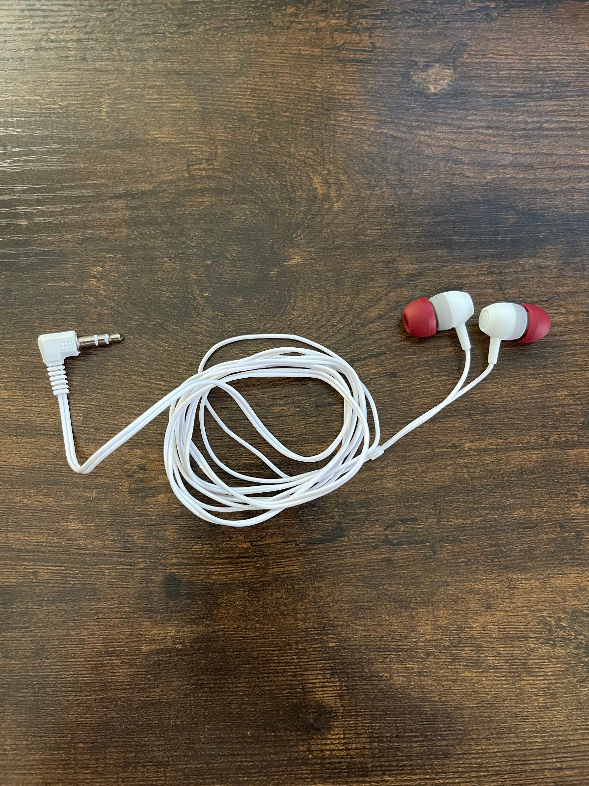 Unbranded White and Red Wired Earbuds with a 3.5 mm Angled Audio Jack Connector